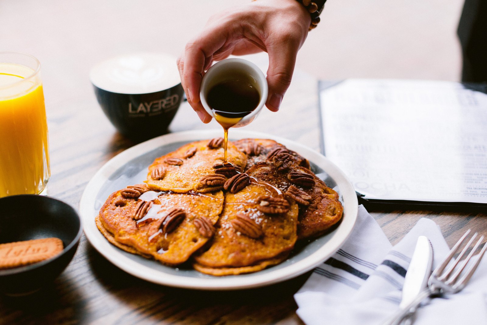 Syrup poured over sweet potato pancakes